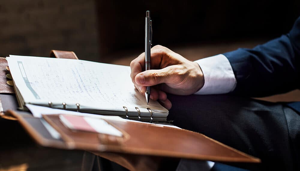 Businessman writing a note